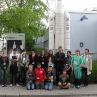 Gruppenbild der deutschen Austauschpartnerinnen und –partner zusammen mit ihrer Führerin (rechts) vor einem Modell der europäischen Trägerrakete Ariane 5 im ESOC in Darmstadt.